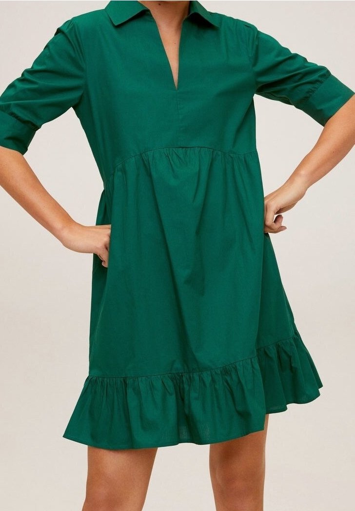 Robe en coton verte avec un col, des manches trois-quart et un ourlet froncé en étages. Texture lisse avec une coupe décontractée.