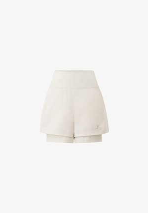 Light beige athletic shorts with a high waistband, featuring a smooth texture and an inner short layer for added coverage. Logo on the side.