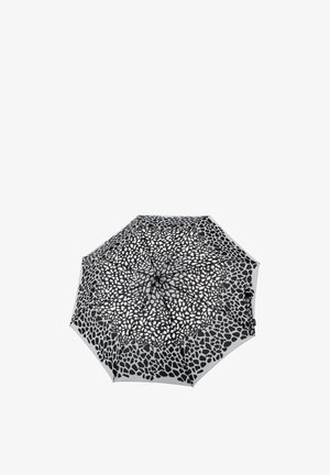 Folded black and white umbrella with irregular pebble-like pattern on canopy, viewed from above against a white background.