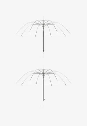 Hand pressing black button on white curved-handle umbrella shaft against white background.