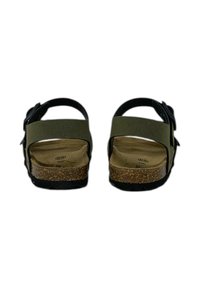 Sandali neri e verde oliva con cinturini regolabili, soletta in sughero e suola in gomma texturizzata. La vista da dietro mostra il design con tacco aperto.