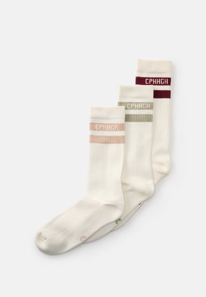 Three pairs of cream-colored ribbed socks with "CPNHGH" text and colored stripes in pink, green, and burgundy at the top.