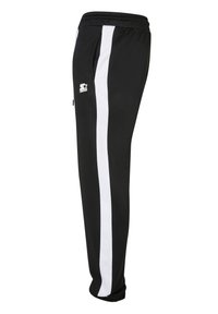 Melni sporta bikses ar baltām sānu svītrām, elastīgu jostasvietu un sašaurinātiem potīšu galiem. Augšējā kreisajā augšstilbā ir logotips. Mīksta auduma virsma.