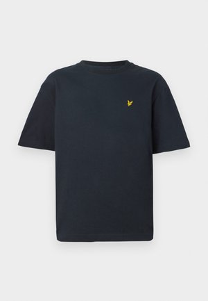 T-shirt en coton bleu marine à manches courtes et col rond, arborant un petit emblème d'aigle jaune sur la poitrine gauche.