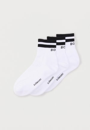 Three pairs of white ankle socks with black stripes and black "BJÖRN BORG" text on cuffs and sole, arranged overlapping on a plain background.