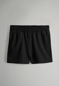 Svart träningstights med elastisk midja, sidofickor och en slät tygkvalitet. Enkelt design, utan mönster eller dekorationer.