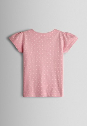 Rožinė medvilninė marškinėliai su trumpomis pūstomis rankovėmis, visur padengta baltų taškelių raštu ir apvalia iškirpte. Lygus audinys.