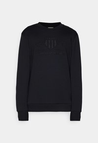 Sweat-shirt noir à manches longues avec poignets et col côtelés, arborant le logo en relief "GANT 1949 American Sportswear" sur le devant.