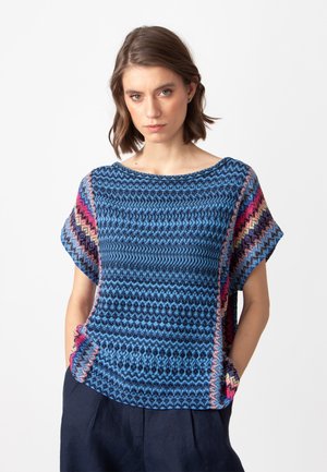 Blue patterned top with short sleeves, featuring a geometric design and pink accents along the sides. Made of lightweight, textured fabric.
