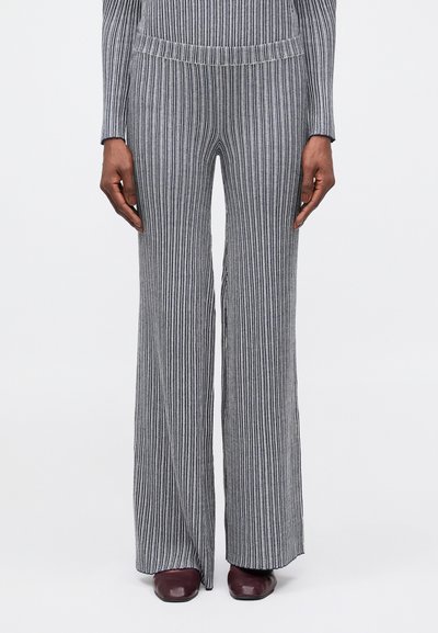 Striped flared pants in gray and navy with a textured knit fabric. Features an elastic waistband and a long, flowing design.
