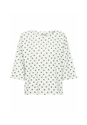 Haut à manches courtes blanc avec des pois noirs, encolure ronde et coupe décontractée. Tissu doux avec une texture lisse.