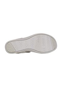 Suela de zapato de goma blanca con un patrón texturizado que presenta líneas curvas y surcos para mayor agarre. Diseño robusto y plano con un borde redondeado.