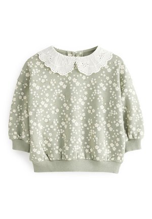 Pull vert clair pour tout-petit avec motif floral blanc, col en dentelle blanche festonnée, poignets et ceinture côtelés.