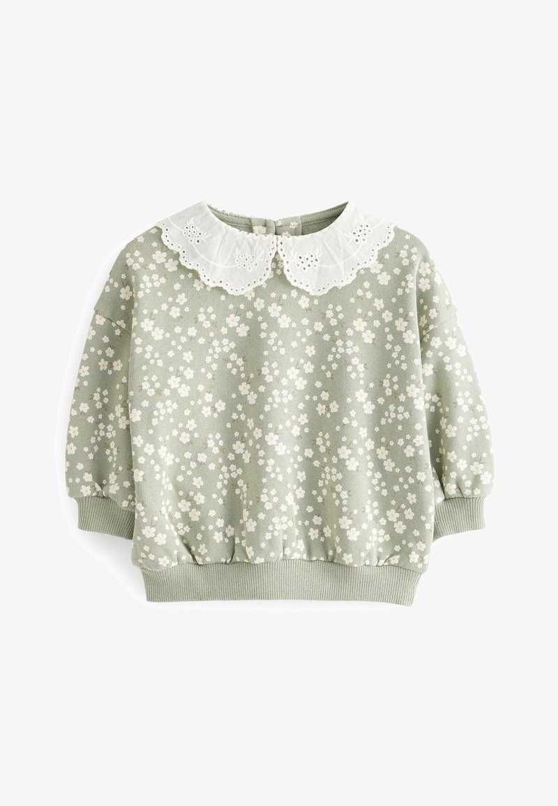 Pull vert clair pour tout-petit avec motif floral blanc, col en dentelle blanche festonnée, poignets et ceinture côtelés.