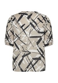 Korte mouw top in beige met een zwart-wit abstract patroon. Heeft een relaxte pasvorm en een gestructureerde stof. Ronde halslijn.