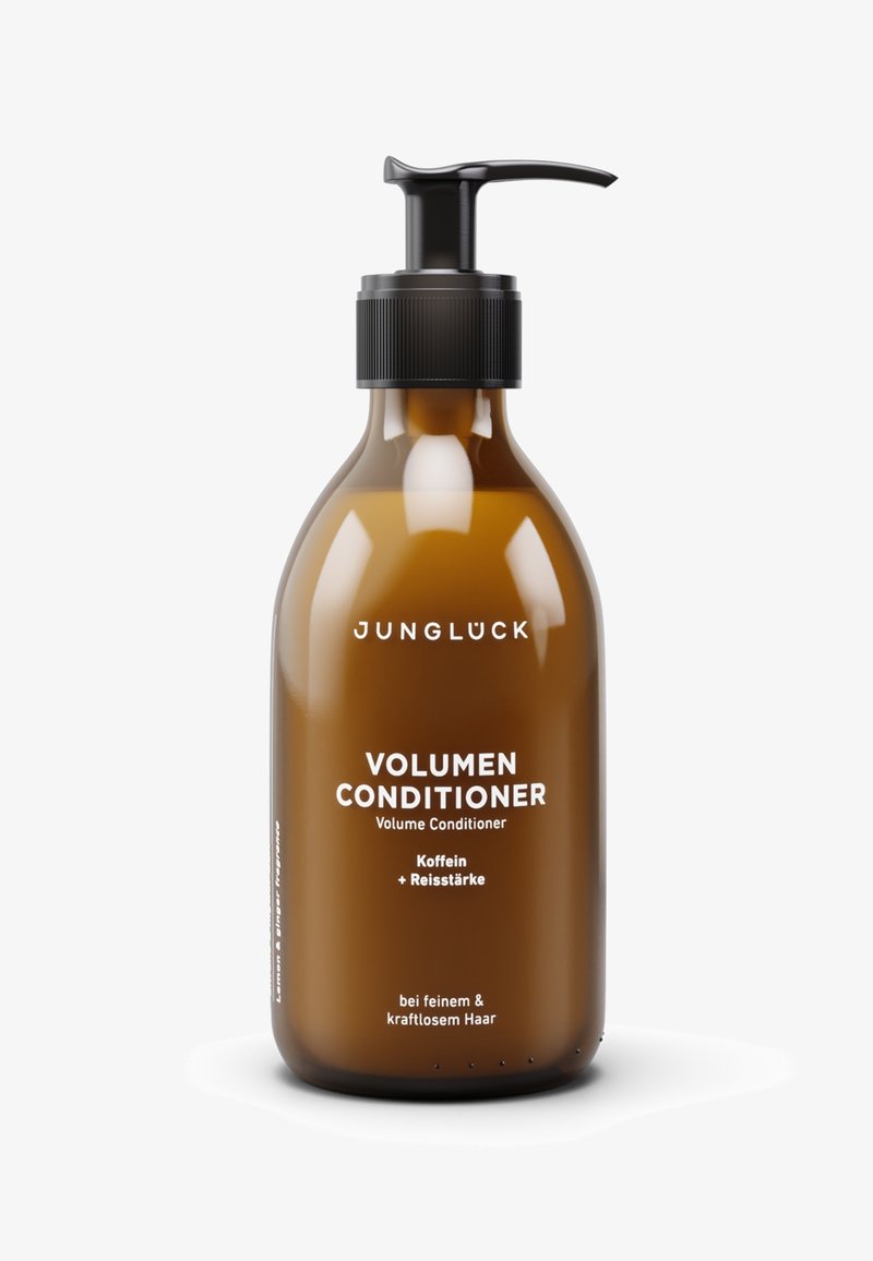 Amber glass bottle with a black pump lid. Label features white text stating "Volumen Conditioner" and ingredients, designed for fine hair.