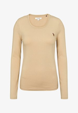 Beige lange mouw geribde shirt met een ronde halslijn en klein geborduurd logo op de borst. Gemaakt van zachte, rekbare stof.