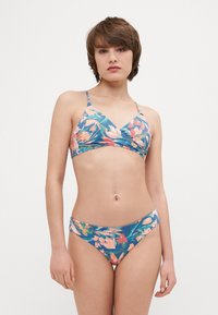 Bikini à motif floral avec une base bleue, agrémentée d'accents roses et verts. Le haut possède des bretelles réglables et un design enveloppant. Le bas est de coupe haute.