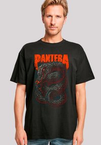 Schwarzes Baumwoll-T-Shirt mit einem großen, roten und grauen Grafik eines Schlangens, darüber der Text "PANTERA" in fetten, abgenutzten orangen Buchstaben.