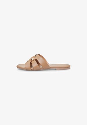 Nude nahka-sandaali, jossa on ristikkäiset hihnat ja pyöreät kultaiset yksityiskohdat. Tasainen pohja, jossa on sileä pinta, minimalistinen muotoilu.