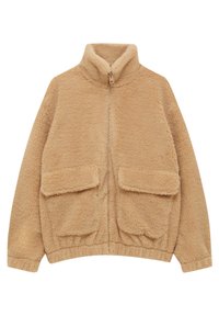 Veste en polaire beige avec un col montant, fermeture éclair à l'avant et deux grandes poches plaquées. Le tissu a une apparence douce et texturée. Ourlet élastique à la taille.