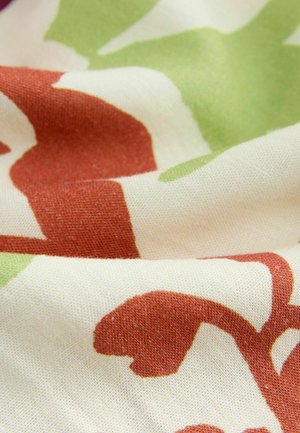 Tissu en coton avec de grands motifs floraux abstraits dans des teintes de vert, d'orange et de crème ; texture douce avec des détails de tissage subtils.
