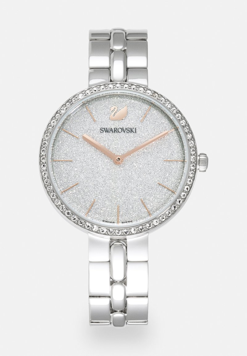 Reloj de metal plateado con una esfera circular, dial plateado texturizado y brillante, manecillas en oro rosado y cristales alrededor del bisel. Presenta una correa de eslabones.