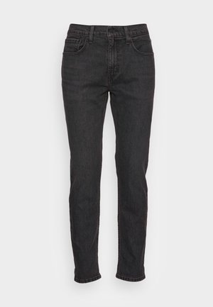 Zwarte denim jeans met een slim fit, voorzien van vijf zakken, riemlussen en subtiele stiksels. Versleten textuur over de stof.