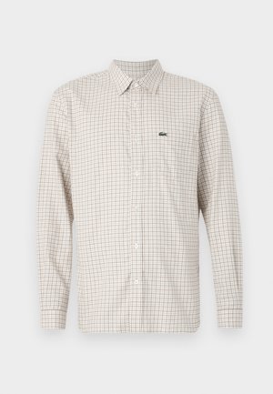 Long-sleeve beige shirt with red and blue grid pattern, buttoned front, collar, and green crocodile logo on left chest.