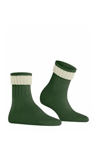 Zielone skarpetki do kostek z kremowym ściągaczem. Wykonane z miękkiej, elastycznej tkaniny, z wzmocnionym palcem i prążkowaną teksturą na całej powierzchni.