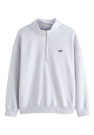 Helehall helkuriga pullover-pusa neljandiku luku ja vasakul rinnal oleva "self." logoga, soonikkoes mansetid ja serv ning kõrge krae.