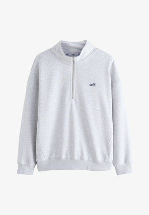 Helehall helkuriga pullover-pusa neljandiku luku ja vasakul rinnal oleva "self." logoga, soonikkoes mansetid ja serv ning kõrge krae.