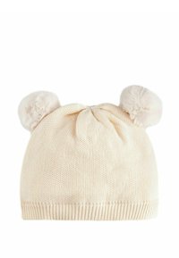 Berretto lavorato a maglia di colore crema con risvolto a coste, decorato con due pompon in faux fur e un dettaglio a fiocco centrale. Texture morbida, design semplice.