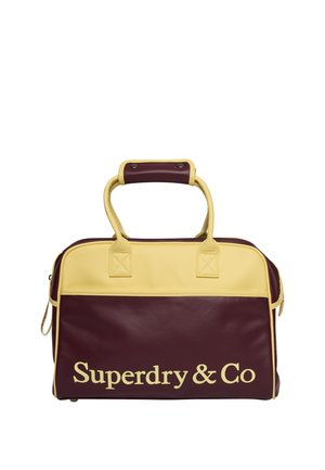 Rectangular maroon and yellow leather bag with handles and "Superdry & Co" printed in large yellow letters on front panel.