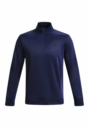 Pull en bleu marine avec un col montant, une fermeture éclair sur le devant à moitié ouvert, des manches longues et un accent de logo. Fabriqué à partir d'un tissu doux et extensible avec une texture lisse.