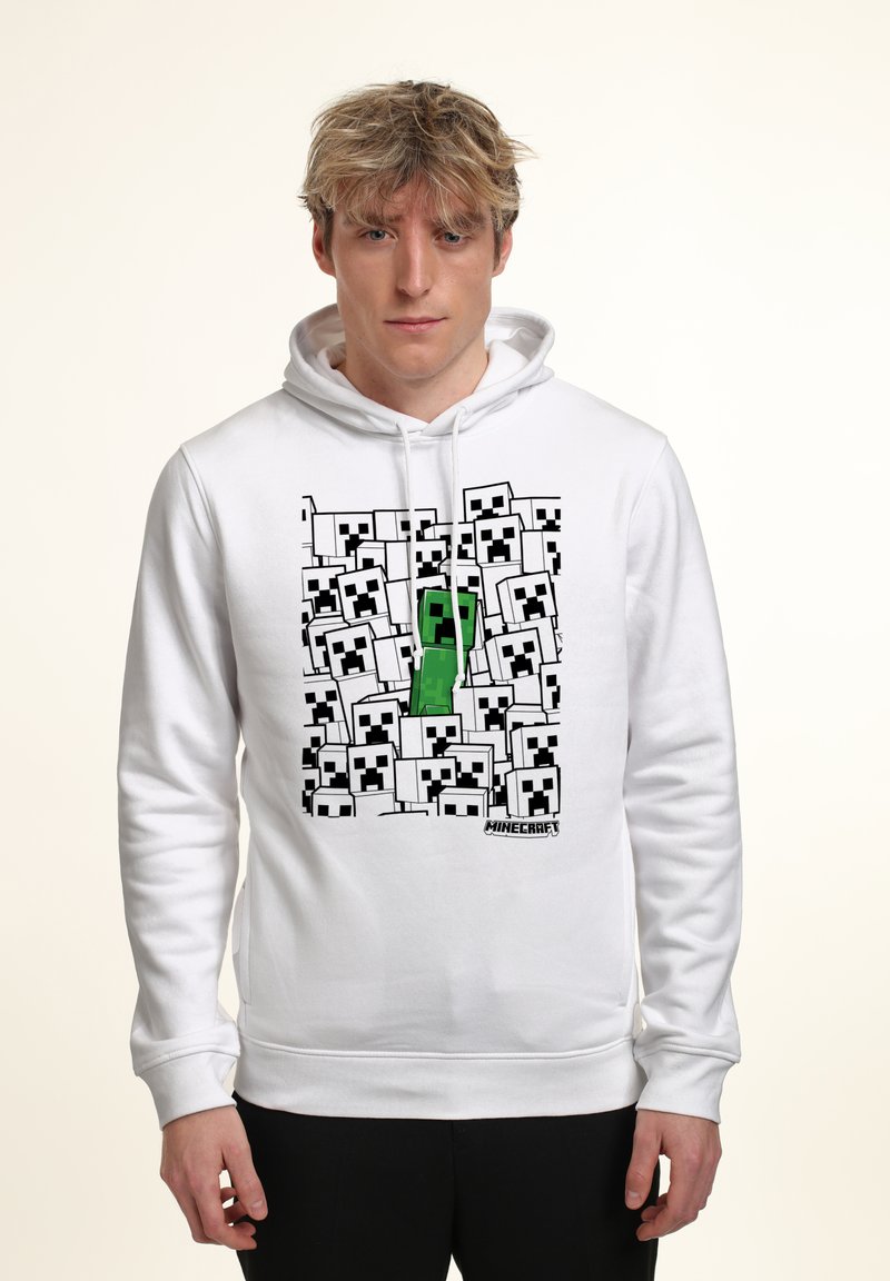 Felpa bianca con cappuccio caratterizzata da un design pixelato di "Minecraft" con numerosi volti di Creeper in bianco e nero, e un elemento centrale verde a forma di Creeper.