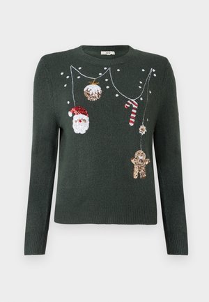 Sötétzöld kötött pulóver ünnepi díszítésekkel, beleértve egy Mikulást, cukorpálcát, díszeket és strasszokkal díszített mackót.