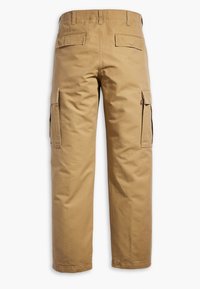 Khaki cargo pants with a loose fit, featuring two side pockets, two back pockets, and durable cotton fabric. Straight-leg design with stitched details.