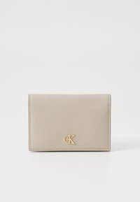 Beige leather wallet featuring textured surface and gold "CK" logo. Compact rectangular shape, with stitched edges and fold-over design.