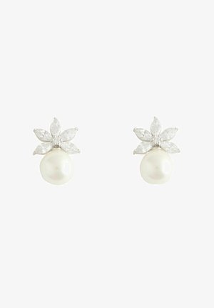 Peal earrings featuring a round white pearl base with a floral cluster of marquise-cut clear stones on top, set in silver.