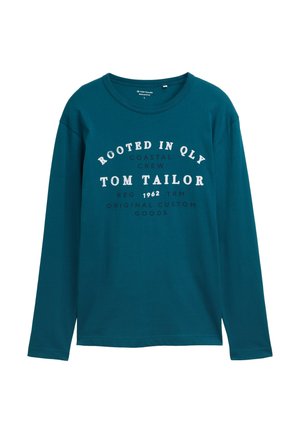 Pamutból készült, hosszú ujjú tótkék póló, kerek nyakkivágással és elöl fehér felirattal: "ROOTED IN QLY, TOM TAILOR, ORIGINAL CUSTOM GOODS."