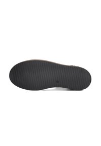 Black rubber shoe sole with a textured, ribbed surface. Slightly rounded at the toe and flat heel. No visible logos or patterns.