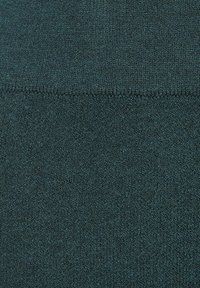 Textured teal fabric with a soft, knitted appearance. The surface features a subtle pattern and a consistent, even texture throughout.