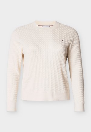 Maglione color crema con motivo a diamante strutturato; girocollo, polsini e orlo a coste; piccolo logo decorativo sul petto. Maniche lunghe.