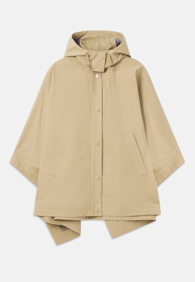 Beige suuri sadetakki hupulla, neppari sulkumekanismilla, säädettävällä kiristysnyörillä ja kahdella etutaskulla; sileä, vedenpitävä kangas.