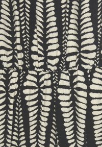 Black fabric featuring white fern leaf patterns. Textured with a slight stretch, showcasing a gathered detail at the waist.