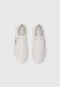 Pair of white low-top sneakers with laces, branded "Blauer USA" inside and on tongue, shown from top view on white background.