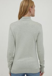 Light gray sweater with a high collar, long sleeves, and a slightly tapered fit. Soft texture with ribbed cuffs and hem. Minimalist design.