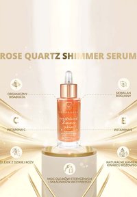 Serum Rose Quartz Shimmer w przezroczystej szklanej butelce z zakraplaczem. Zawiera błyszczącą różowo-pomarańczową ciecz i złote akcenty.