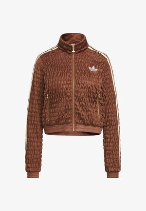 Καφέ κουκουλωτό βελούδινο μπουφάν Adidas με πλήρες φερμουάρ, όρθιο γιακά, πλευρικές τσέπες με φερμουάρ, ριμπ μανσέτες και λευκές τρεις ρίγες στα μανίκια.